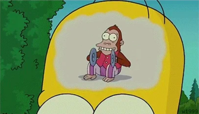 Zoomed in brain of Homer Simpson showing a crazy monkey bouncing 2 plates.